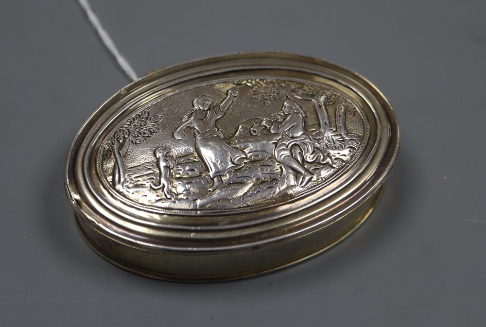 A 19th century continental embossed gilt white metal oval snuff box, unmarked, 75mm, 56 grams.